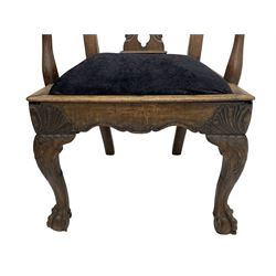 Unusual 18th century mahogany elbow chair, the shaped cresting rail with projecting shell carved ears, pierced and scroll carved splat over drop-in upholstered seat, shaped arms with ball and claw carved terminals, the seat rails carved with shell cartouches, on foliate carved cabriole supports with ball and claw feet 