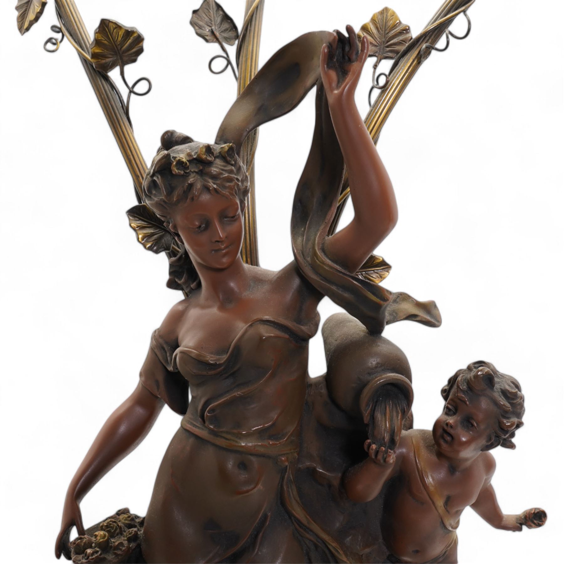 Pair of large bronzed resin figural table lamps, modelled as a young woman and cherub, issuing three naturalistic branches, entwined with flowering tendrils, with three frosted glass shades, on simulated marble base, H84cm (2)