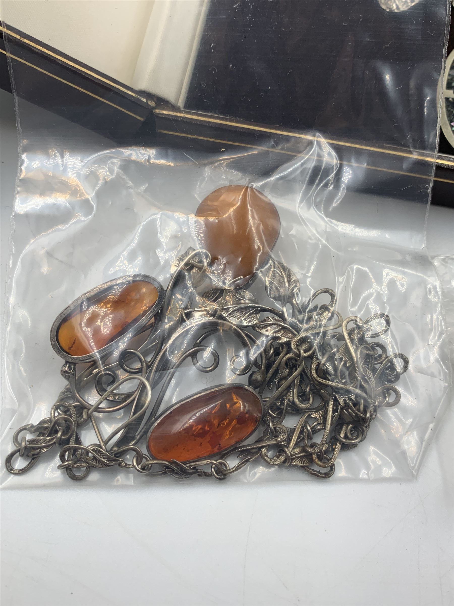 Silver jewellery, including an amber set necklace, pair of earrings and pin, silver charm bracelet, silver ingot pendant, filigree jewellery and other silver jewellery