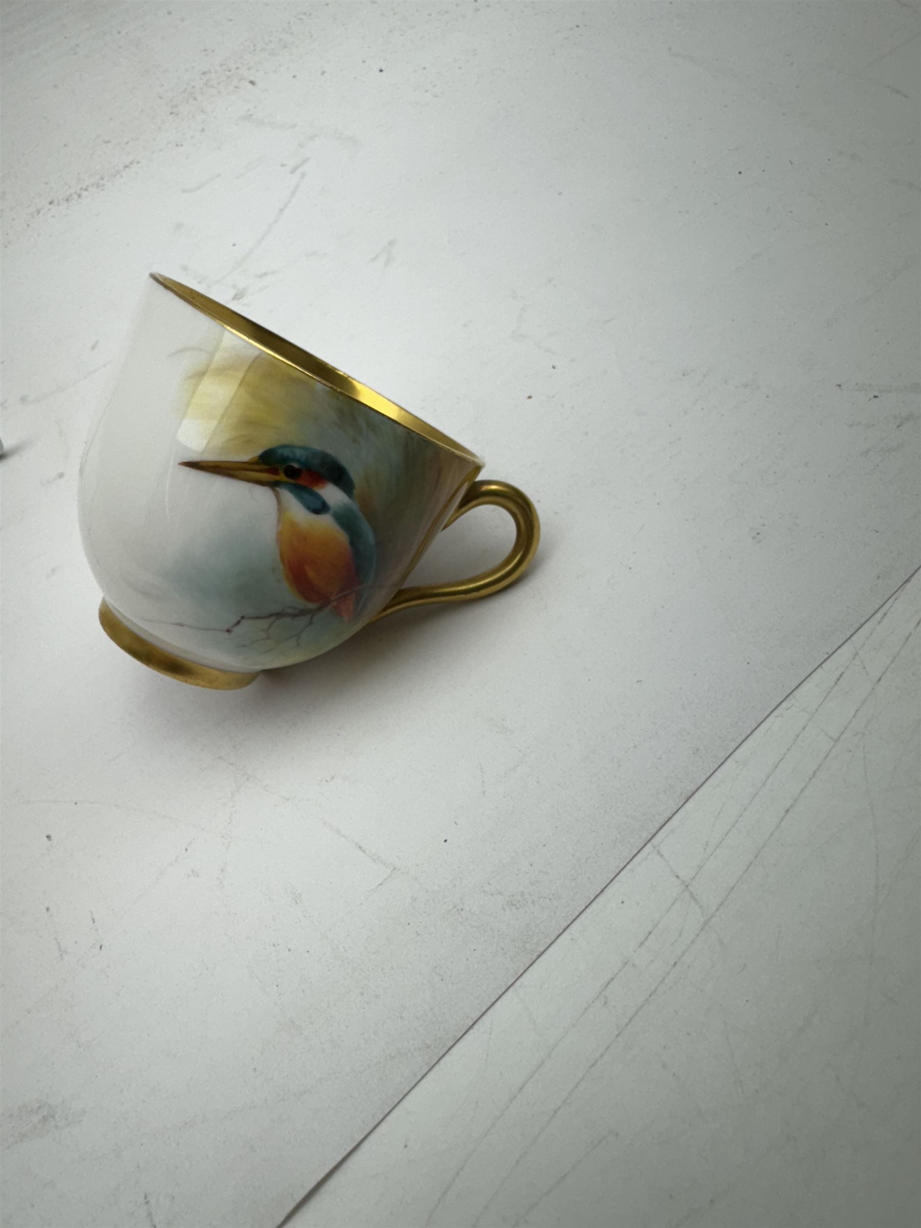 Royal Worcester cabinet cup, decorated with a kingfisher upon a branch by H. Powell, artist signed, together with matching saucer by other artist