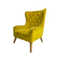 Mid-20th century design armchair, barrel back upholstered in buttoned mustard fabric, on tapering splayed front feet