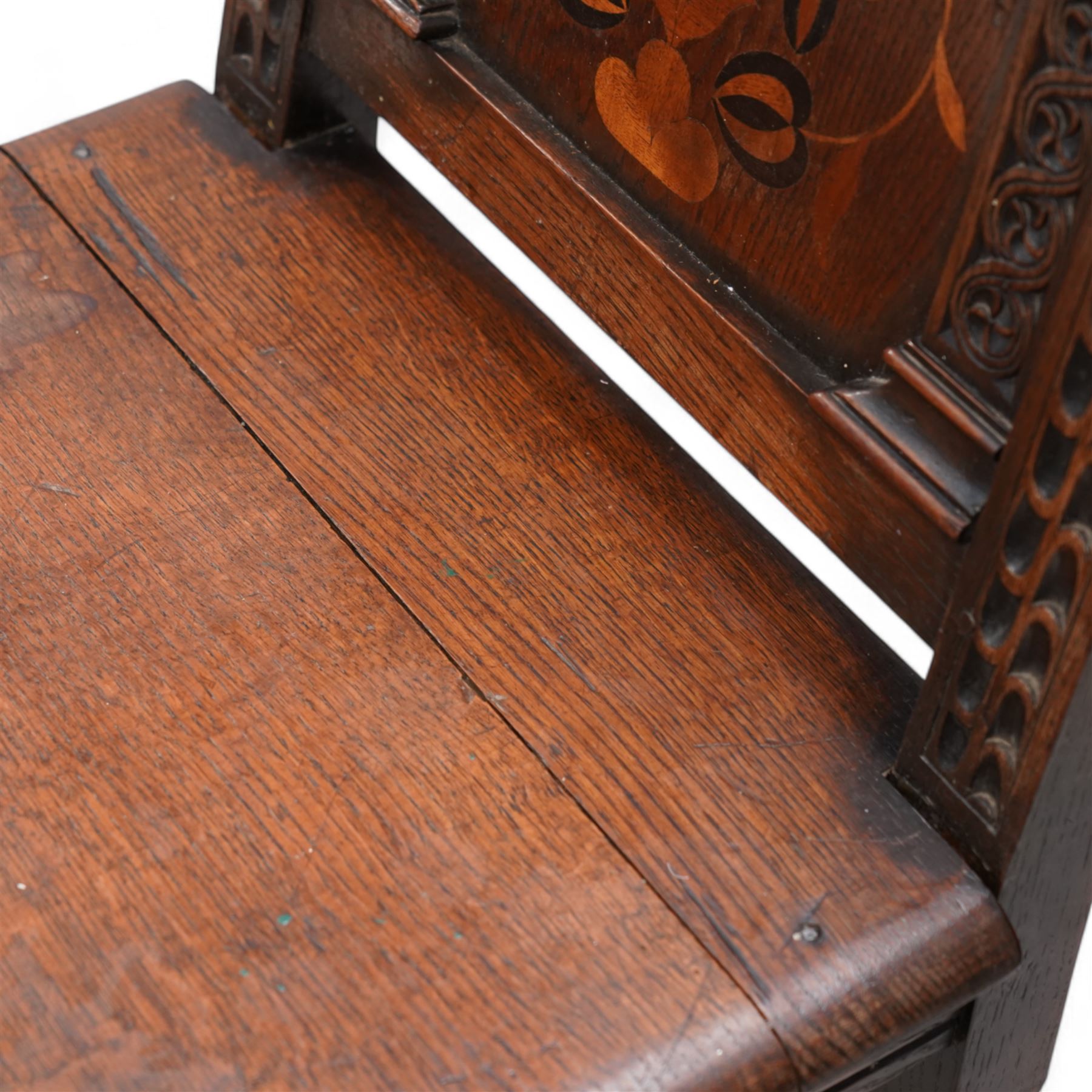 Pair of 19th century Dutch style marquetry oak hall chairs, cresting rail carved with a central green man mask with flanking scrolls, the panelled back inlaid with a bird motif within a guilloche carved arch, panelled seat over scrolling foliate carved apron, on ring turned supports united by box stretcher