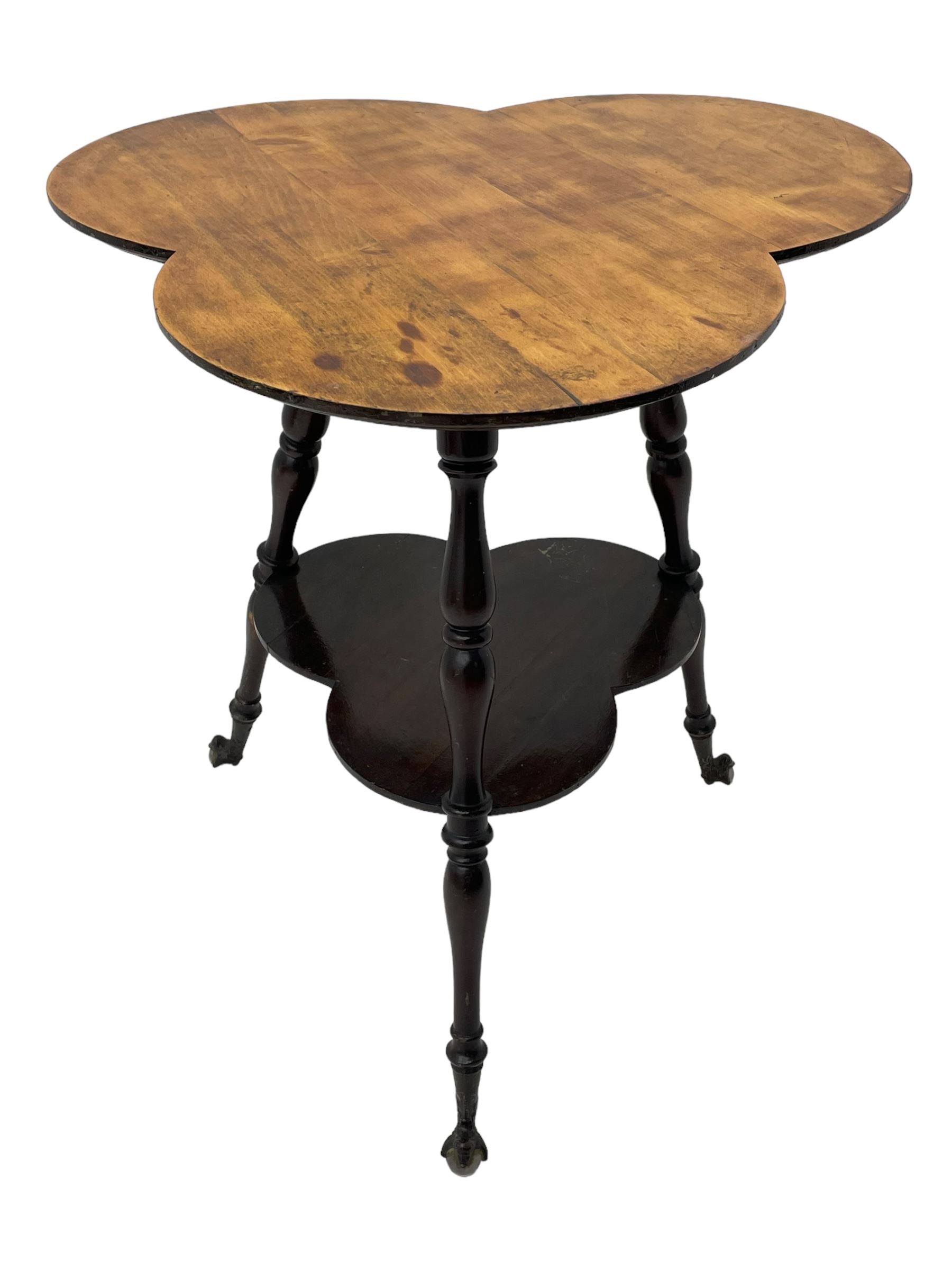 Late 19th to early 20th century stained beech 'Gypsy' table, trefoil or clover shaped top on turned supports united by undertier, on cast metal and glass ball feet 