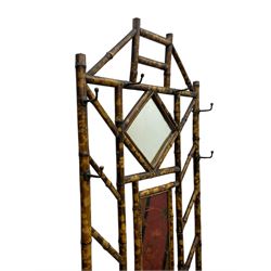 Victorian bamboo hallstand, bevelled mirror over red lacquered and chinoiserie decorated panels, fitted with six brass hooks 