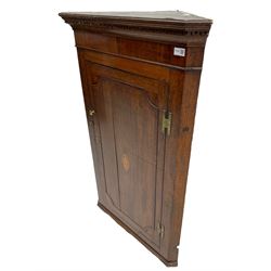 George III oak and mahogany wall hanging corner cupboard, single door decorated with central inlaid shell motif enclosing three shelves