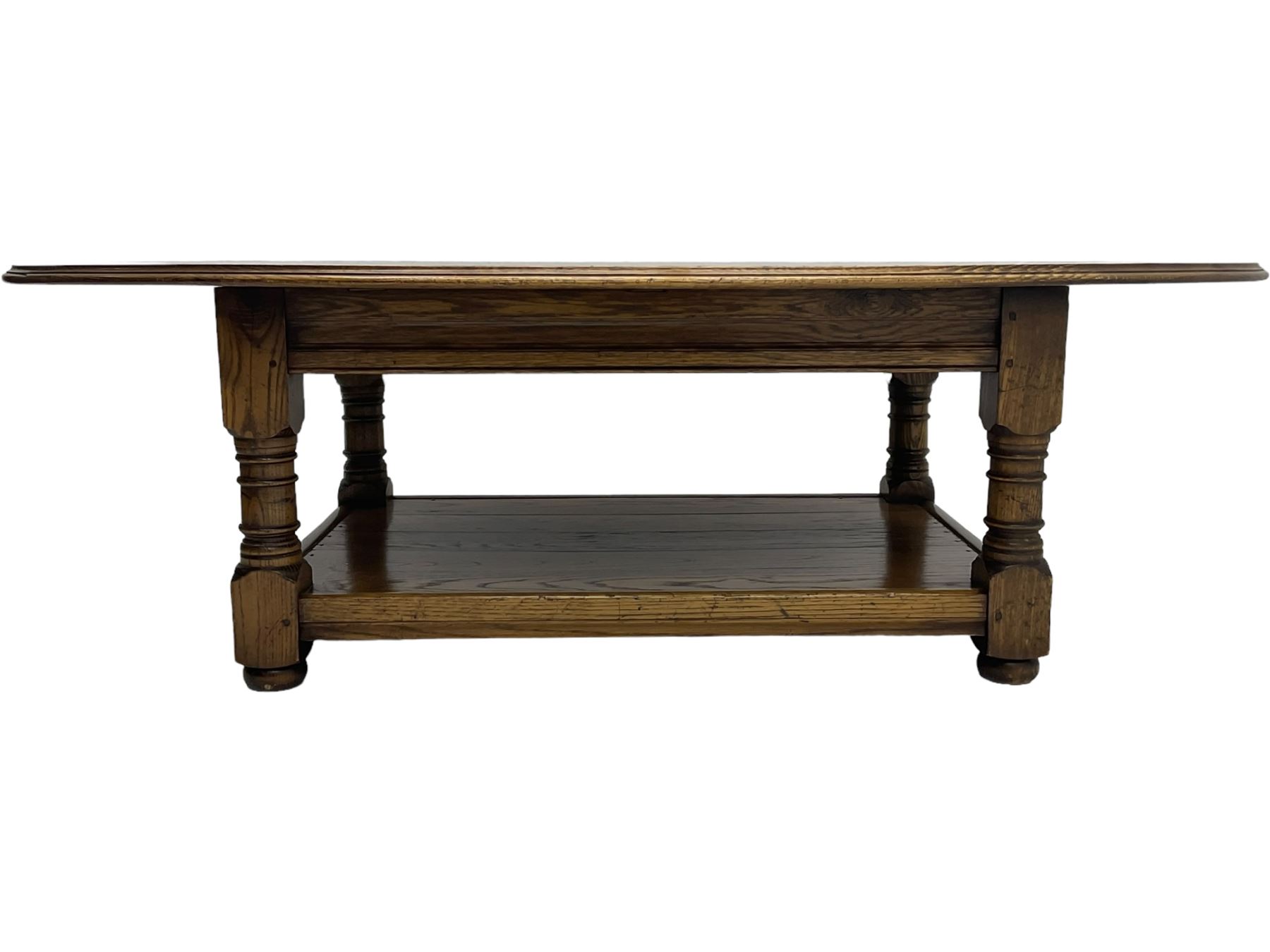 Traditional oak coffee table, moulded oval top, four turned pillar supports united by undertier