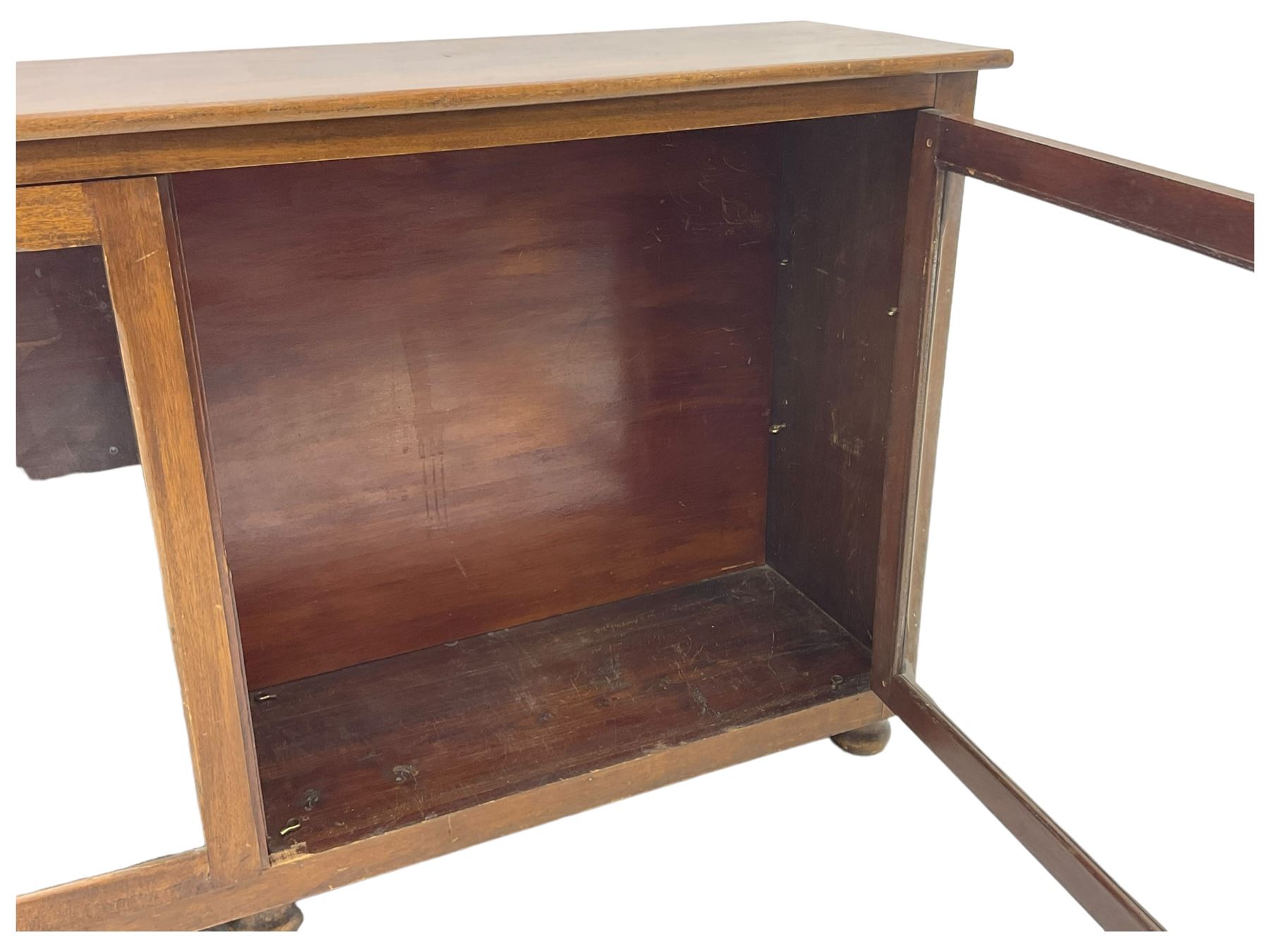 Early 20th century mahogany bookcase, rectangular top over two glazed doors, fitted with four adjustable shelves, on turned bun feet 