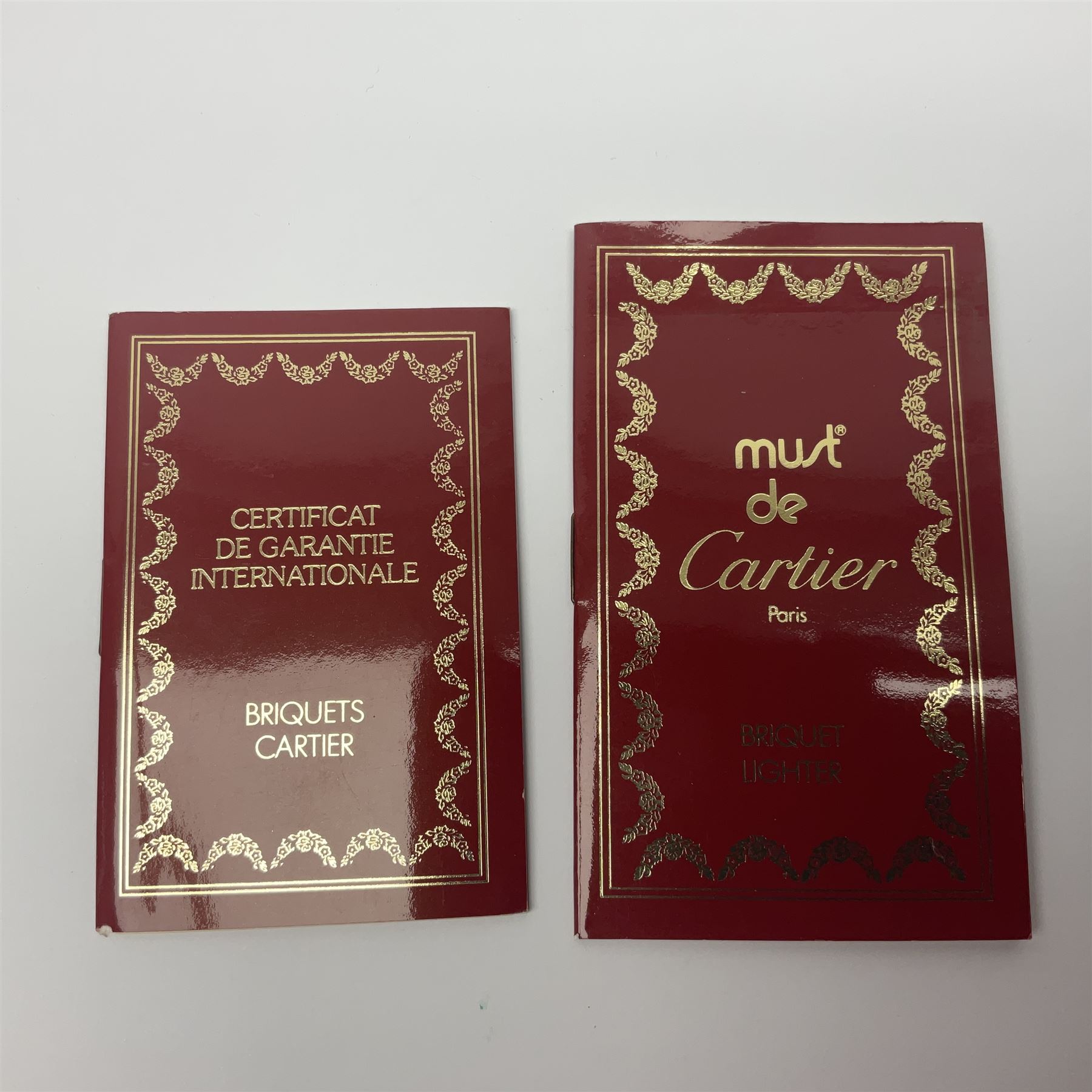 Must de Cartier stainless steel lighter, with gold plated accents, stamped Cartier to base, boxed with guarantee