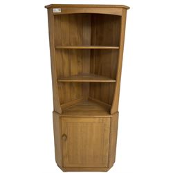 Ercol - mid-20th century '743C'  light elm corner cabinet, fitted with two open shelves over a single cupboard