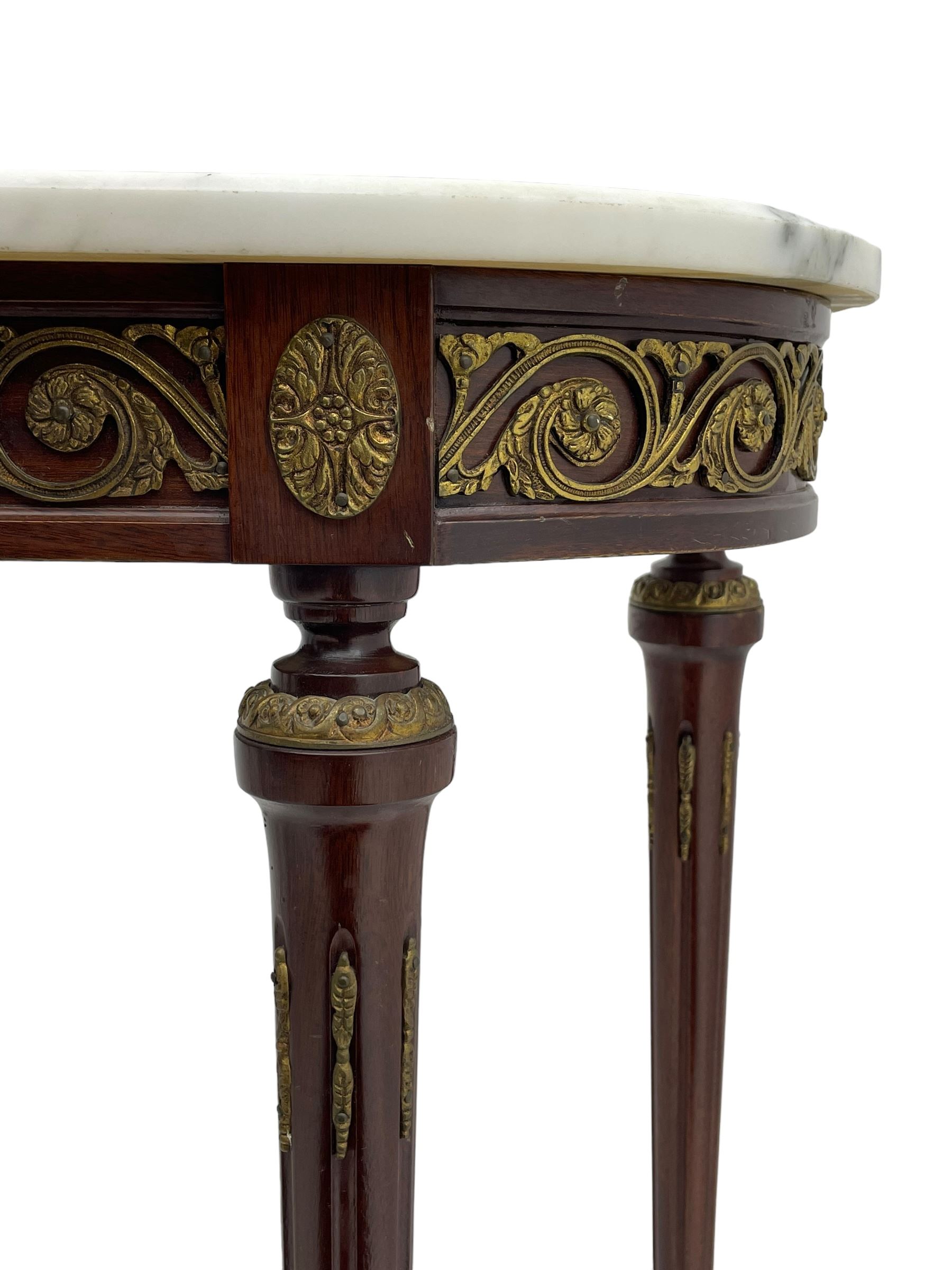 Pair of late 20th century French design mahogany console tables, D-end form with white and grey veined marble tops, the frieze rails decorated with scrolled leaf and flower head cast brass mounts, on turned and fluted supports with cast brass mounts and feet 