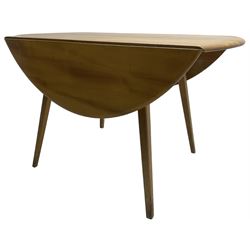 Ercol - mid-20th century golden elm drop-leaf dining table, circular top over splayed supports