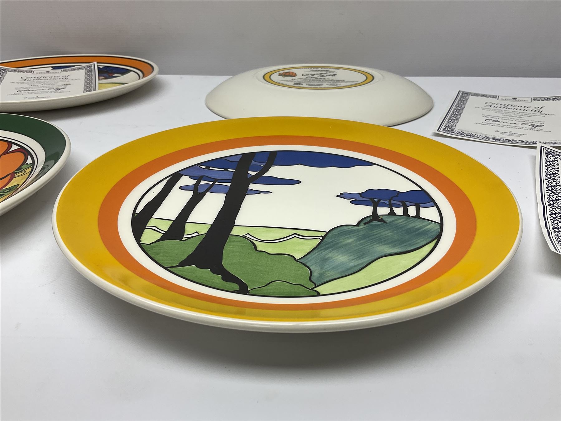 Four Clarice Cliff Wedgwood limited edition plates, comprising Orange Erin, Blue Firs, Solitude and May Avenue, all with certificate and box, D26cm