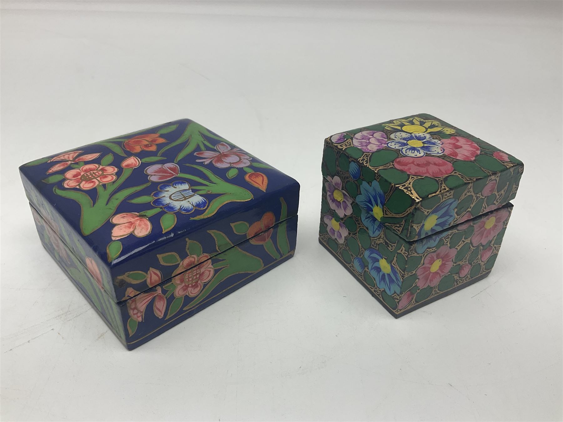 Twelve lacquered boxes, to include square and oval examples, with floral decorations, tallest H5cm