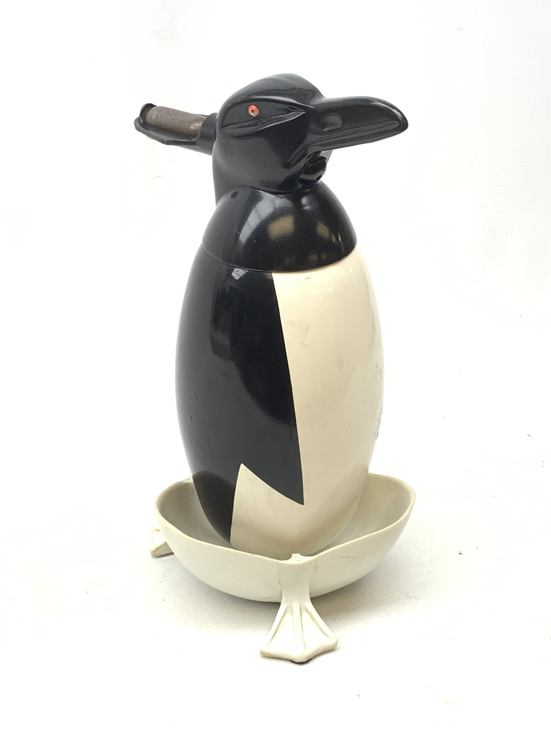 A Russian Soviet period soda siphon, modelled as an enamel penguin, and raised upon a plastic drip tray, H35.5cm 