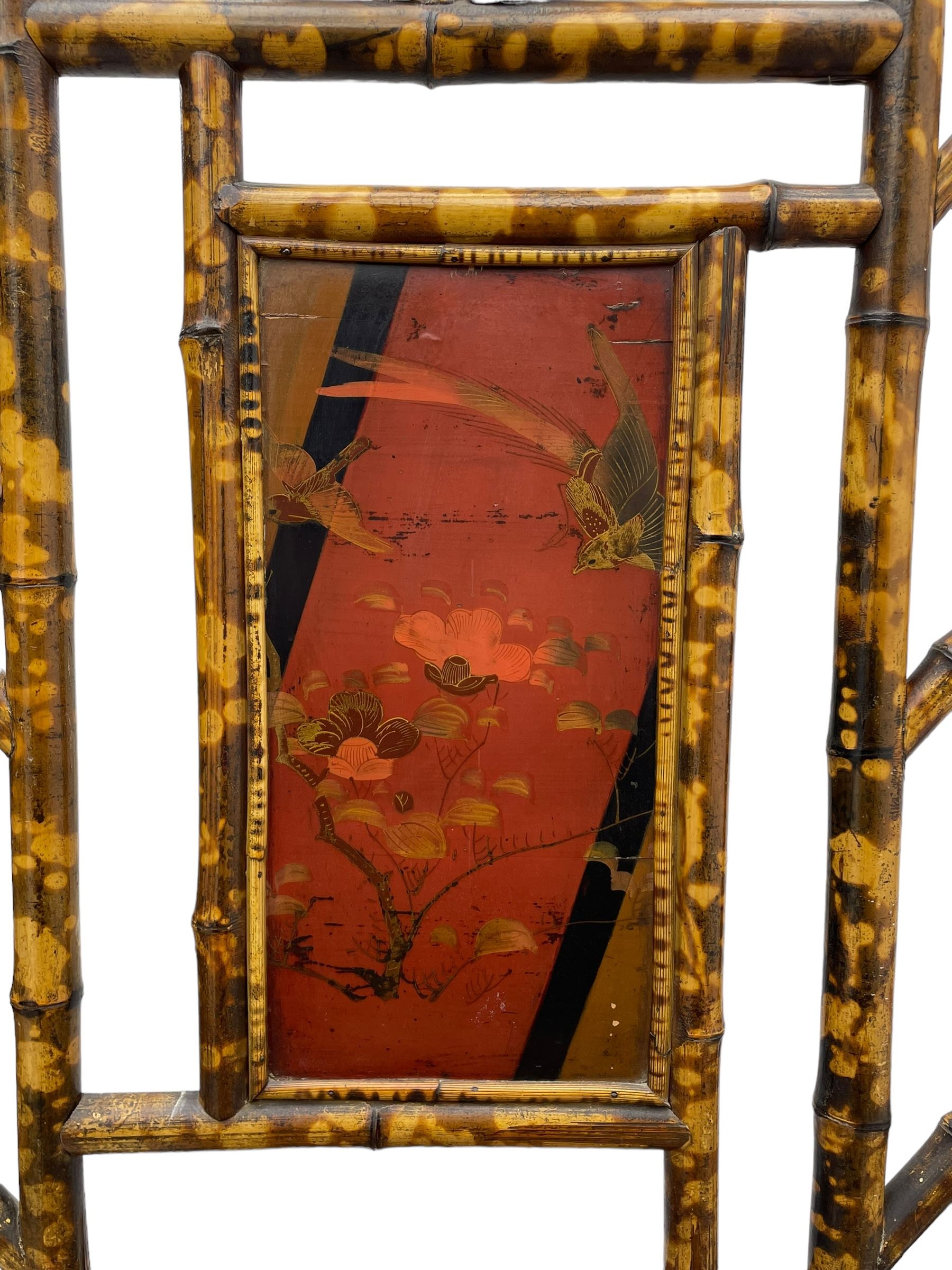 Victorian bamboo hallstand, bevelled mirror over red lacquered and chinoiserie decorated panels, fitted with six brass hooks 