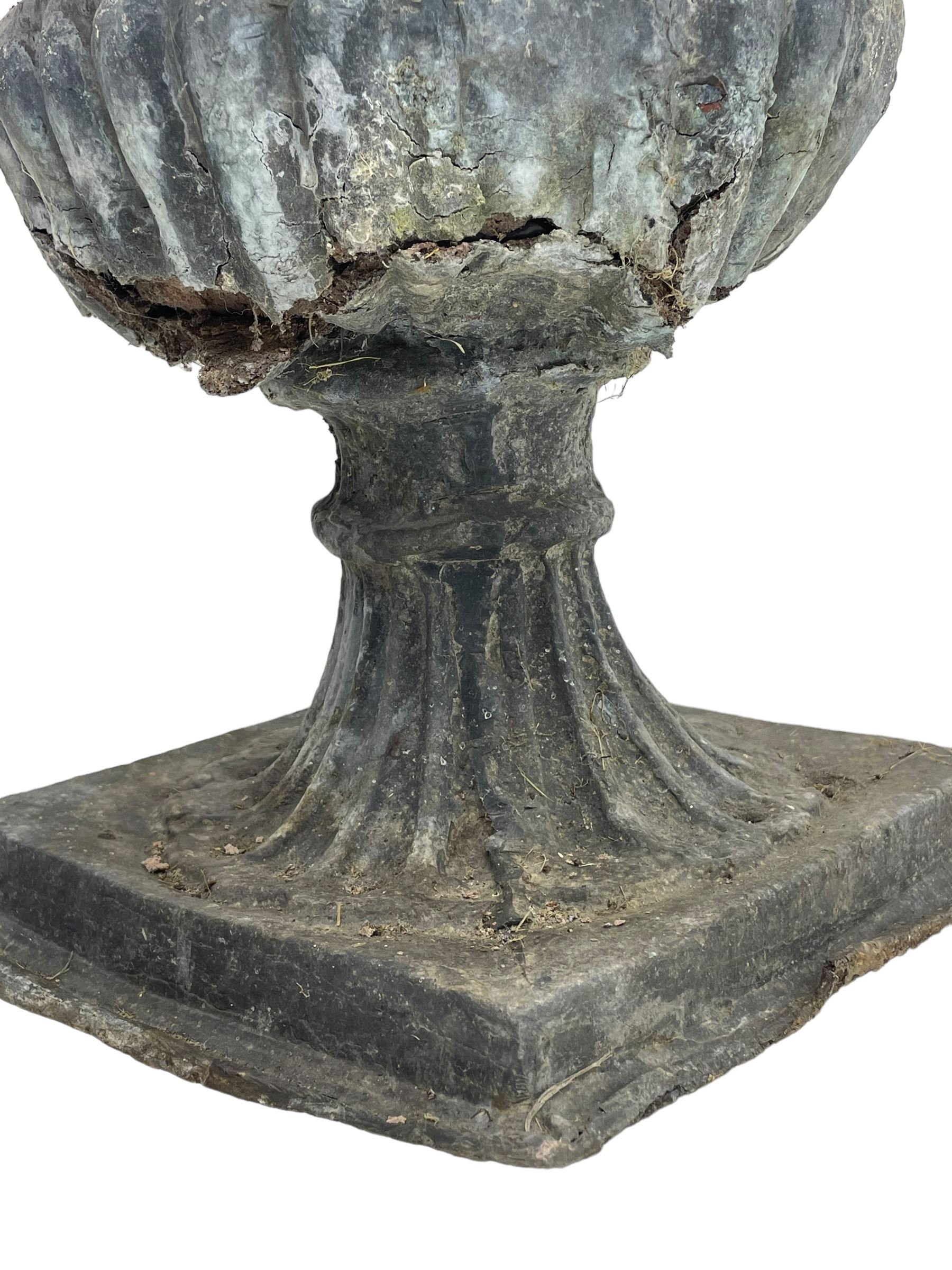 Pair of 19th century lead Campana shaped garden urns, egg and dart moulded rim, tapered fluted body over gadrooned underbelly, tapered and fluted foot on moulded square base 