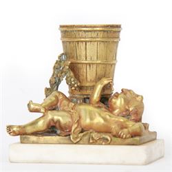 Gilt metal spill vase, the vase modelled as a a barrel with putti amongst fruiting vines laid before, upon rectangular base and rectangular marble plinth, H13.5cm