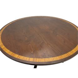 Georgian design inlaid chestnut wood centre table, the circular tilt-top inlaid with satinwood banding, gun barrel turned pedestal on four out-splayed supports, cast brass hairy paw castors, stamped 'P.H.R & Co. Holt, England' 