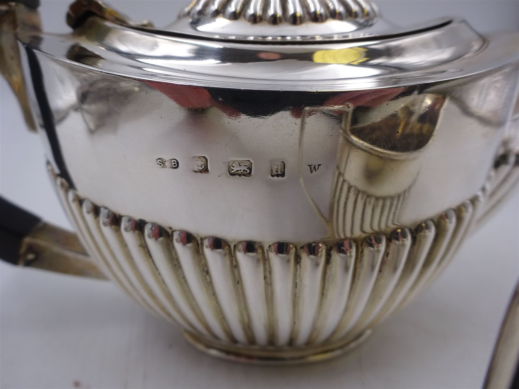 Edwardian silver bachelor's two piece tea set, comprising teapot and milk jug, each of oval part fluted form, the teapot black plastic handle and finial, hallmarked Synyer & Beddoes, Birmingham 1903, teapot H10.5cm