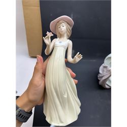 Group of Lladro figures, to include May Dance no 5662, examples modelled as a female golfer, young woman holding sheep in her arms, pair of figures in pink dressed holding sun hats, etc., together with two Nao figures and a further Spanish example, (11)