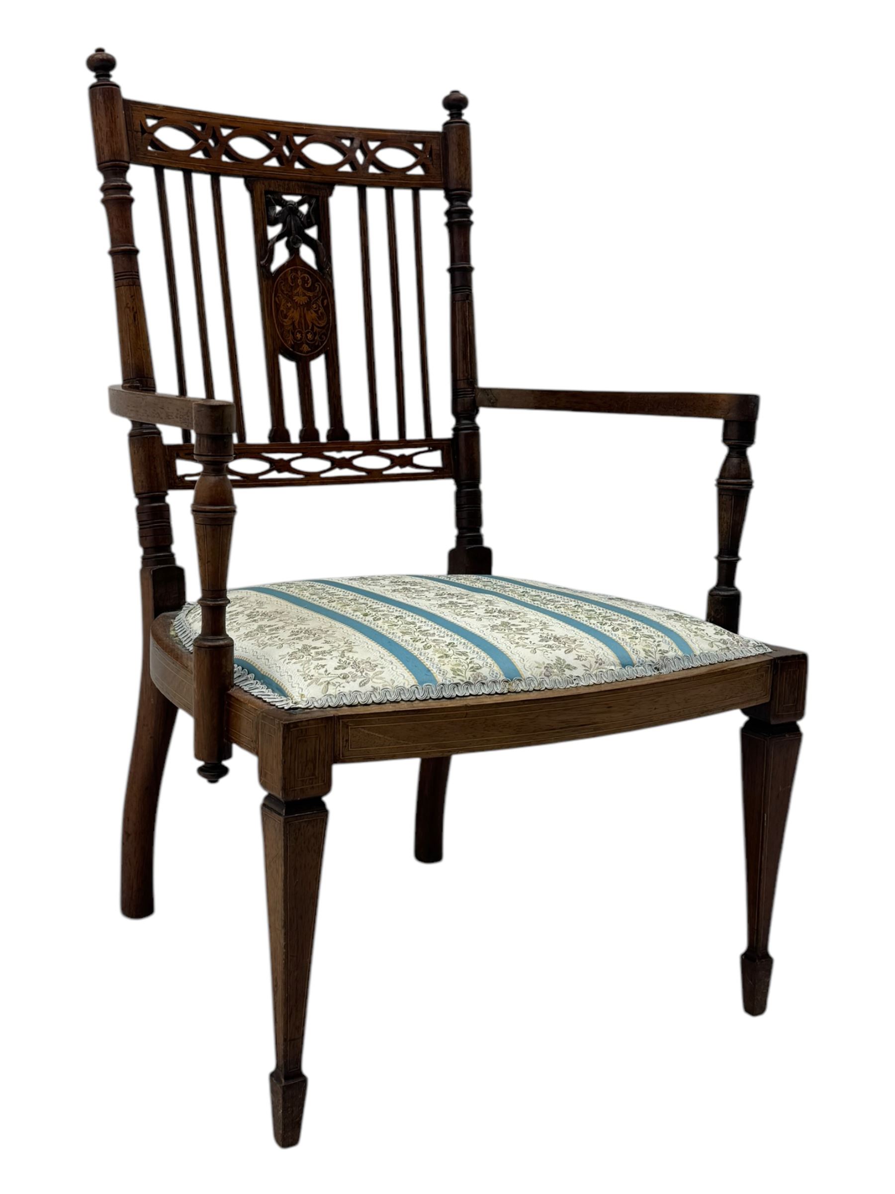 Edwardian inlaid rosewood elbow chair, pierced cresting rail over carved ribbon tie and oval inlaid panel, upholstered in stripe and floral pattern fabric, on square tapering supports with spade feet 