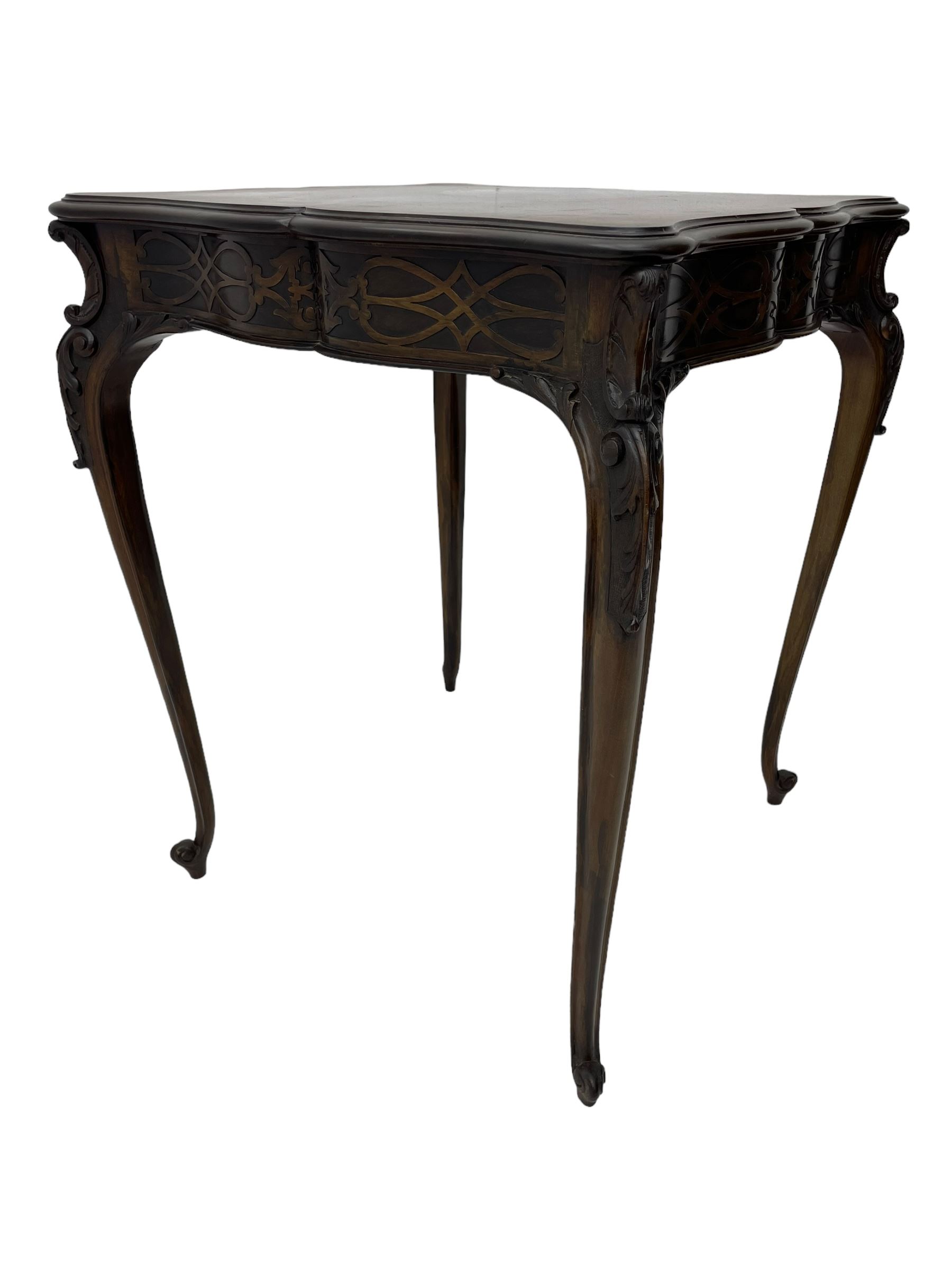 Early 20th century mahogany centre table, shaped moulded top over shaped frieze rails decorated with blind fretwork, on C-scroll and acanthus leaf carved cabriole supports with scrolled terminals 