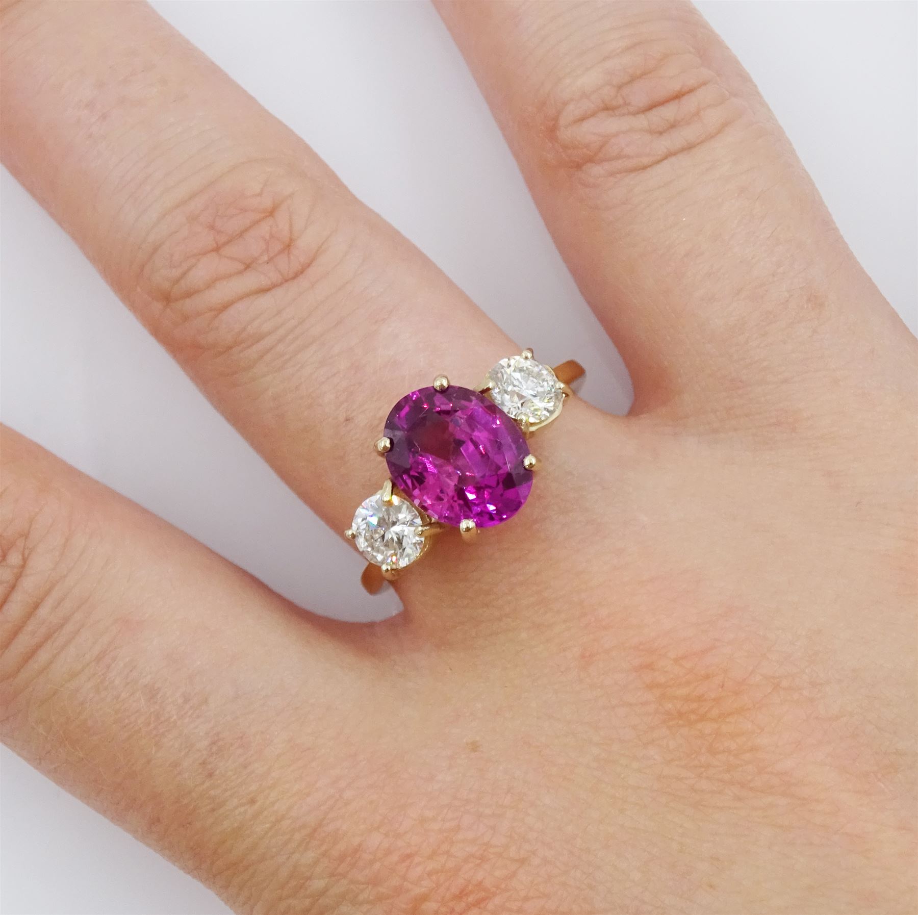 18ct gold three stone oval cut pink sapphire and round brilliant cut diamond ring, hallmarked, sapphire approx 3.00 carat, total diamond weight approx 0.80 carat