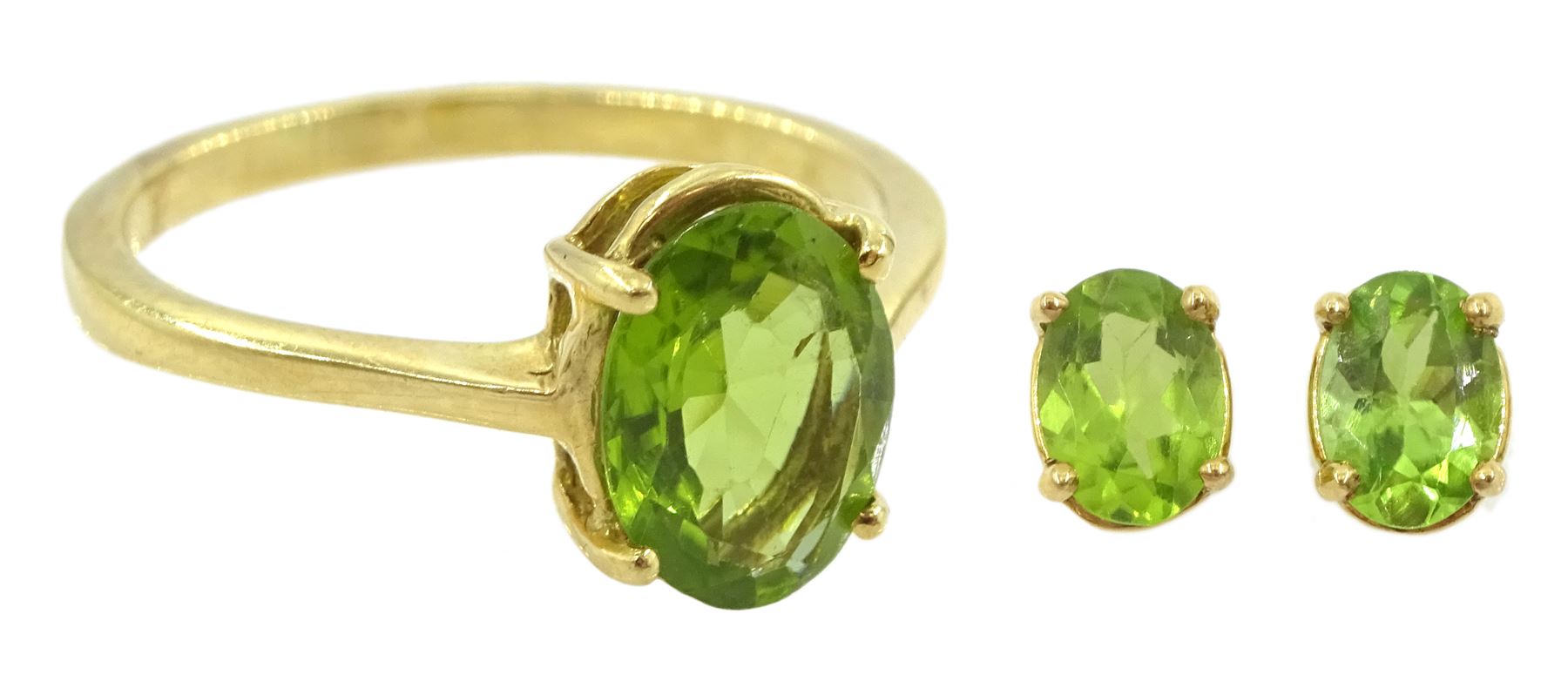 Gold single stone oval cut peridot ring and a similar pair of peridot earrings, both 18ct