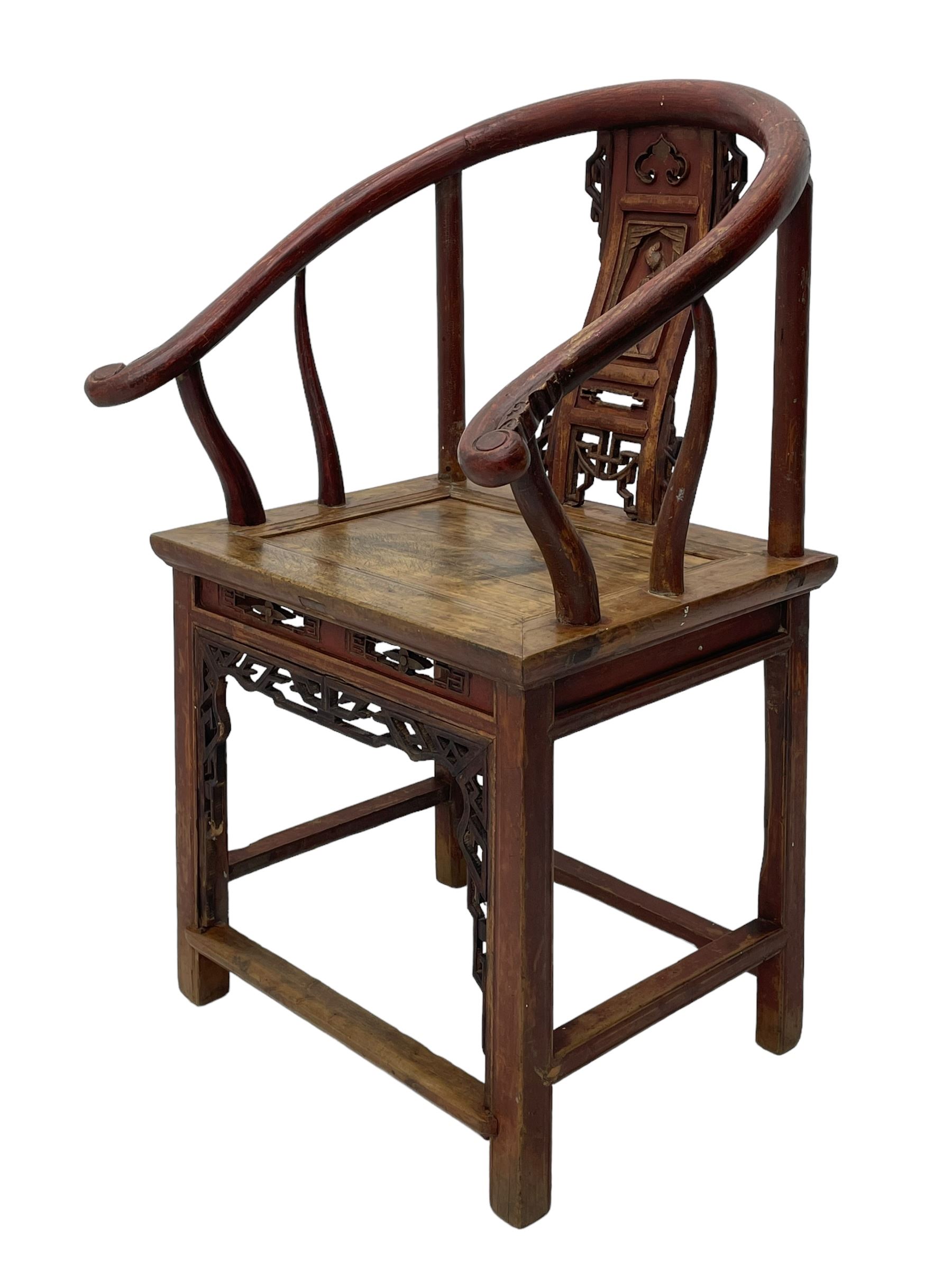 Late 19th century Chinese Qing dynasty horse shoe armchair, in elm, hung mu and Chinese softwood, horse shoe shaped upper rail carved with scroll terminals, shape back carved with solitary figure in robes, rectangular panelled seat in moulded frame, decorated with fretwork panels, on square supports united by stretchers 