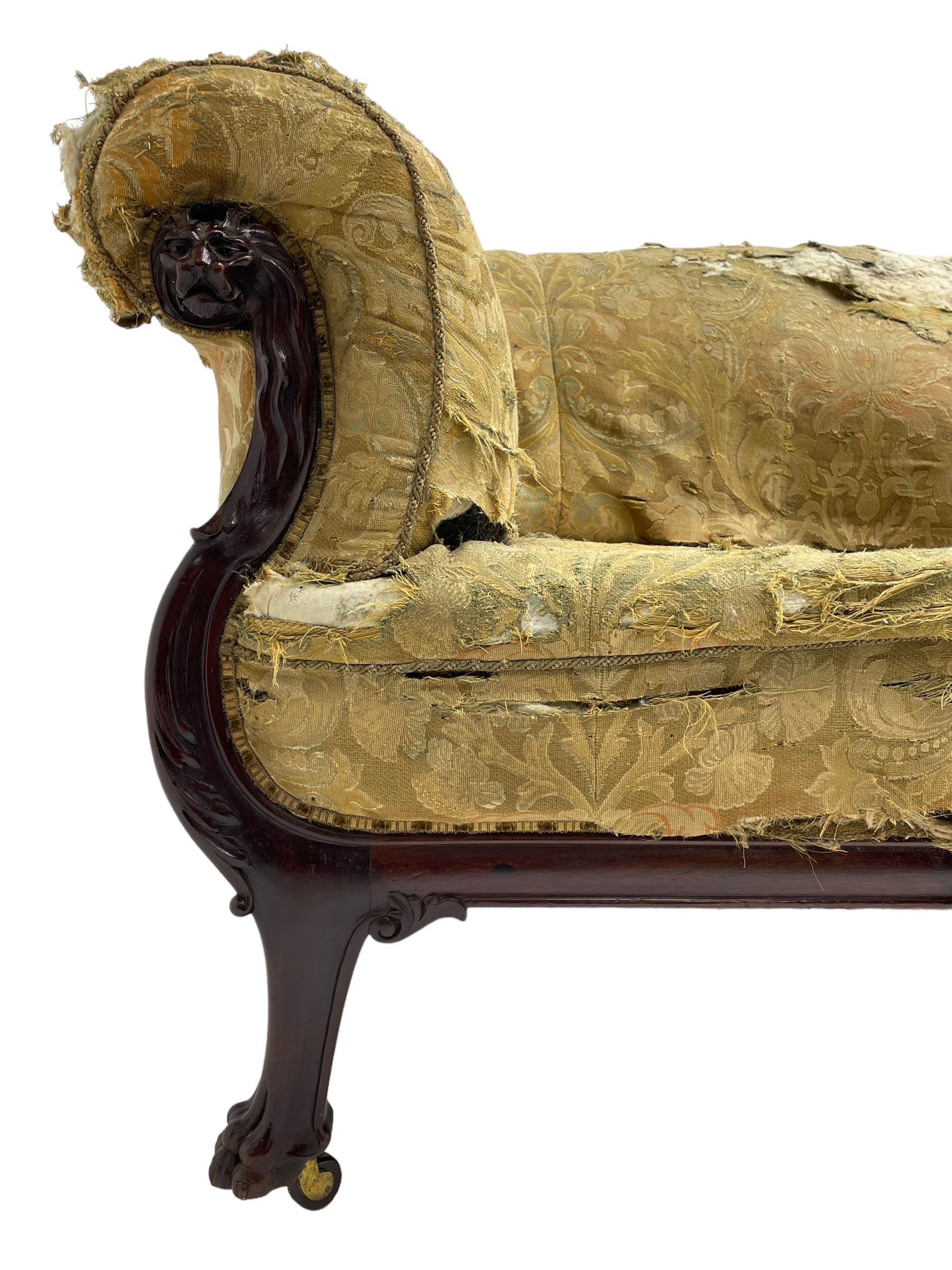 19th century mahogany settee, rolled S-scrolled arms carved with lion masks and acanthus leaf scrolls, the lower moulded rail carved with scrolling design, raised on carved paw feet with recessed brass and ceramic castors 