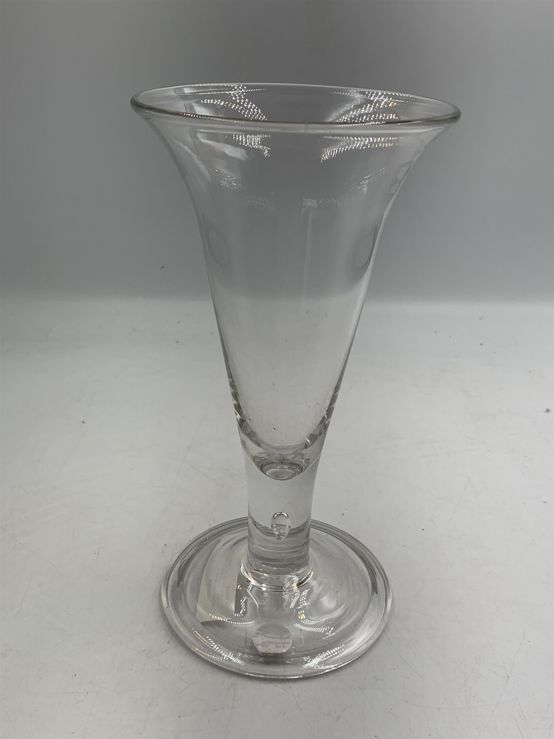 Large 18th century ale glass, circa 1780, with drawn trumpet bowl and flared rim, teardrop stem on a domed folded foot, H20cm