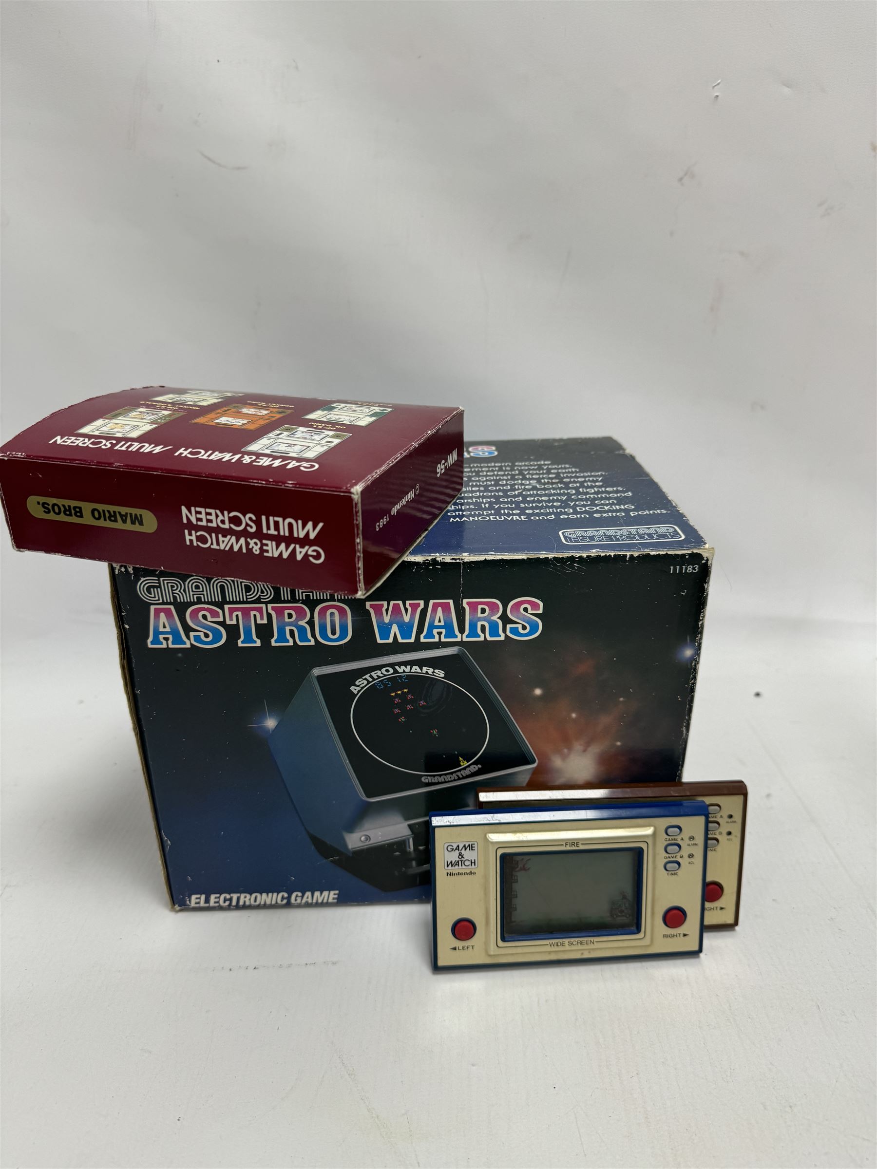 Three 1980s Nintendo Game & Watch handheld electronic games, to include a boxed Multi Screen Mario Bros example and two unboxed single screen examples Parachute and Fire, together with a Grandstand Astro Wars electronic game, boxed with instructions