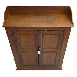 Victorian pine cupboard in scumbled oak finish, the raised back over chamfered rectangular top, enclosed by two panelled doors, the interior fitted with two shelves
