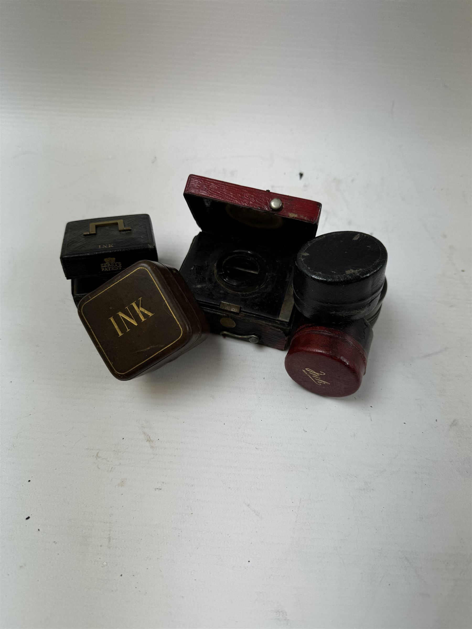 Six leather bound travelling inkwells, to include Berry's Patent example, all with glass liners