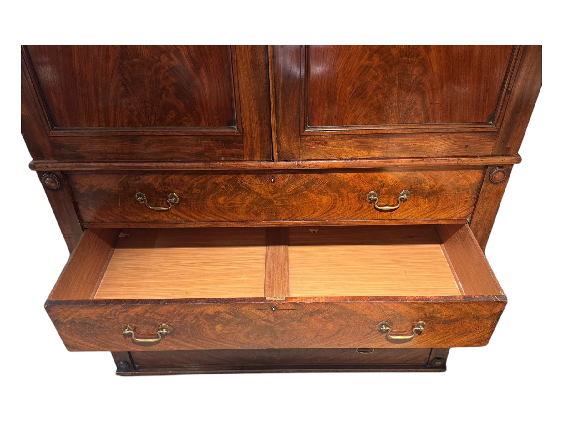 Victorian mahogany linen-press, moulded cornice over two figured panelled doors, the interior fitted with five slides and hanging rail, four long drawers below 