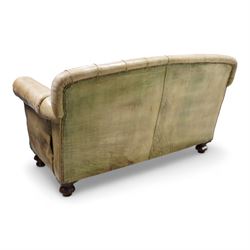 Drop-end two-seat sofa, upholstered in deeply buttoned pale green leather with stud work, on turned feet