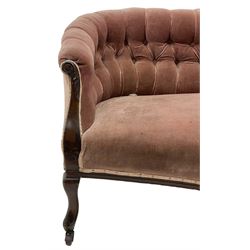 Late 19th century mahogany framed two-seat sofa, upholstered in buttoned pink fabric, on cabriole front supports, on castors 