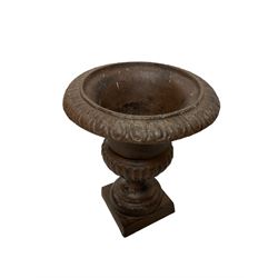 Two pairs of cast iron Campana-shaped garden urns, egg and dart moulded rim over gadrooned underbelly, on circular foot and square base 