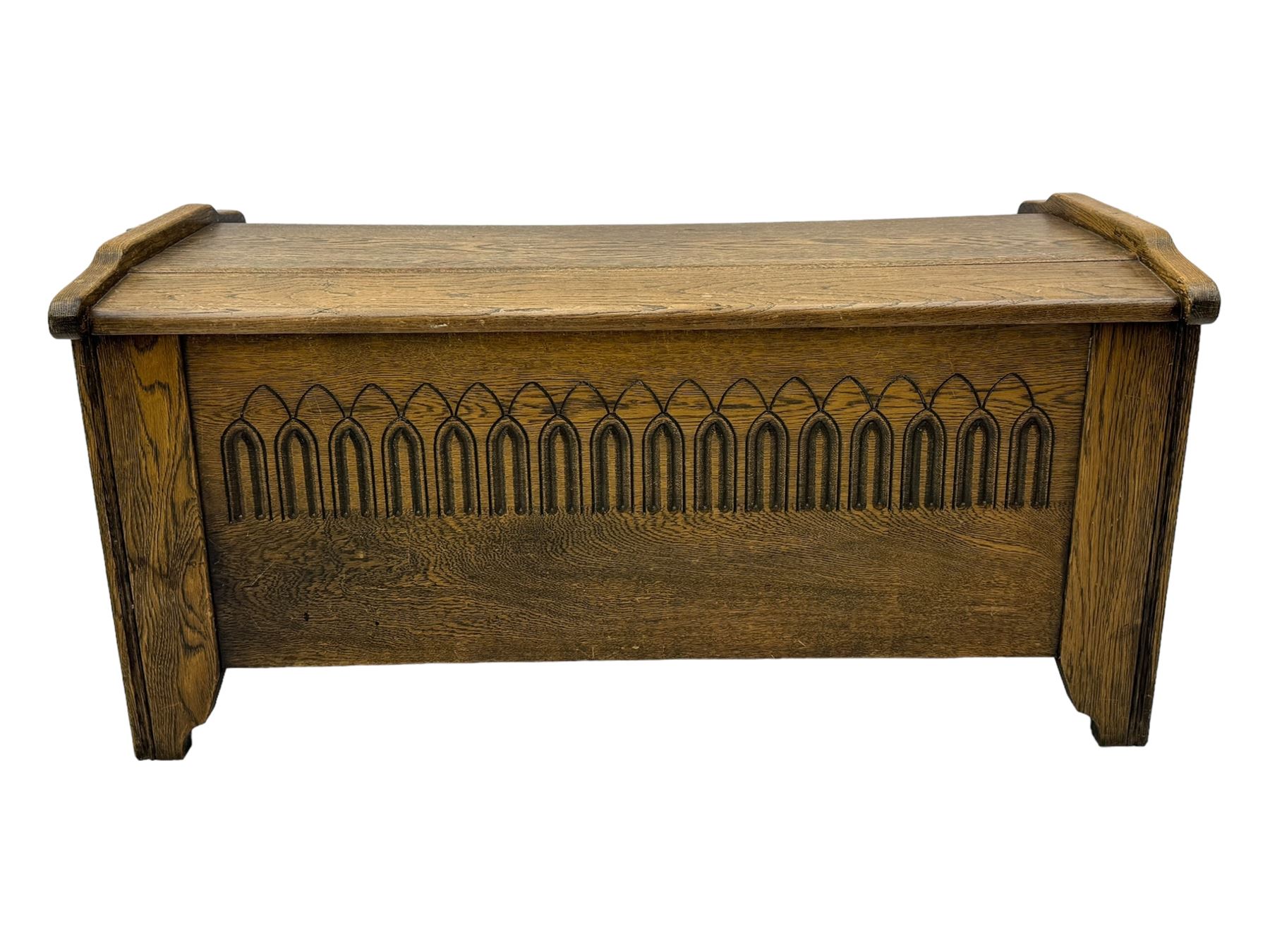 20th century oak coffer or blanket chest, rectangular hinged top over repeating Gothic arch carved front and shaped sides, constructed with pegged joints, on stile supports