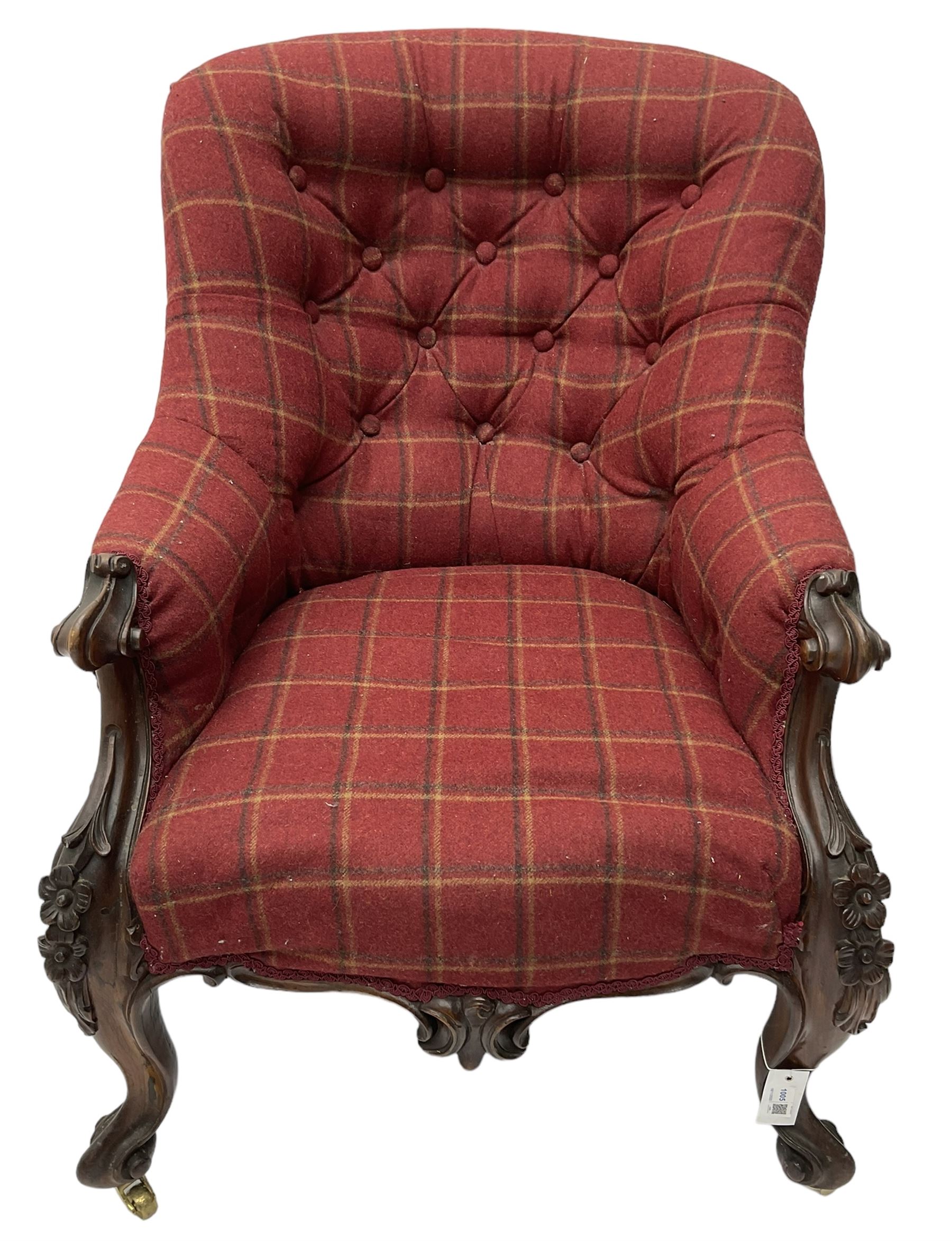 Victorian rosewood framed armchair, upholstered in buttoned tartan fabric, scrolled arm terminals graduating into cabriole supports with moulded flower head decoration and cartouche carved apron, over scroll feet with brass castors