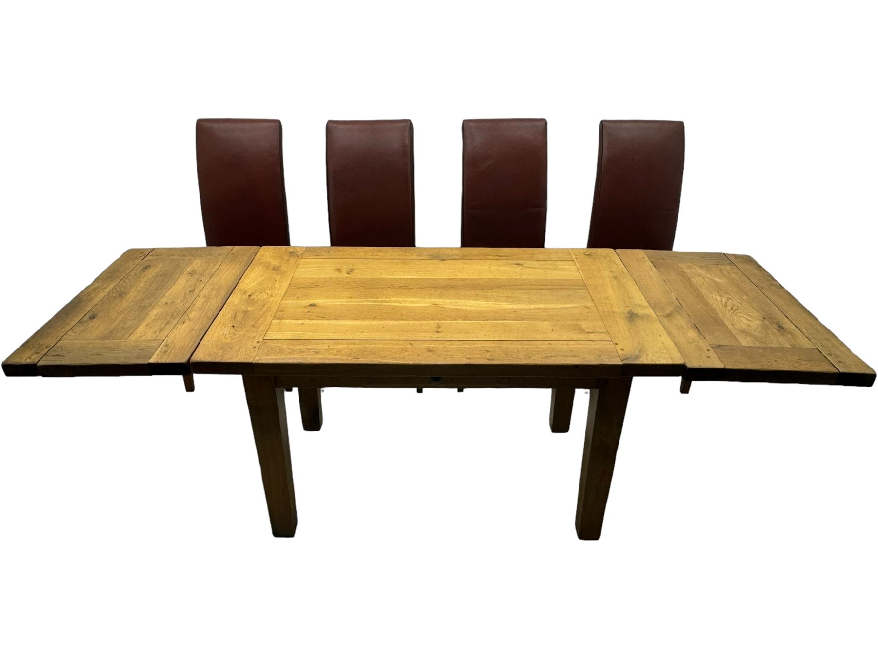 Oak dining table, rectangular plank with two extension leaves at each end, central drawer with brass handle, supported by square legs (L131cm - 233cm, D80cm, H76cm); four high-back dining chairs, the chairs upholstered in dark brown leatherette with stitched detailing, on square tapering legs (H108cm)