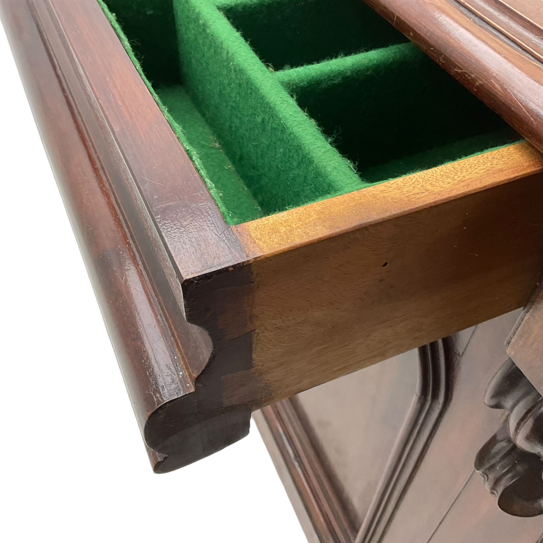 Victorian mahogany chiffonier, raised shaped back with foliage scroll carved mounts, on fretwork and carved bracket supports, moulded rectangular top over two frieze drawers and double panelled cupboard, on moulded plinth base