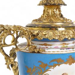 Pair of 19th century Sevres pattern porcelain and ormolu six light candelabra, each with branches cast as lilies, carnations etc, the two handled vase shaped base with oval panels painted with cherubs amongst flowers on a bleu de ciel surround and raised on an ormolu foliate stem and circular base with scrolling bracket feet H76cm (2)  