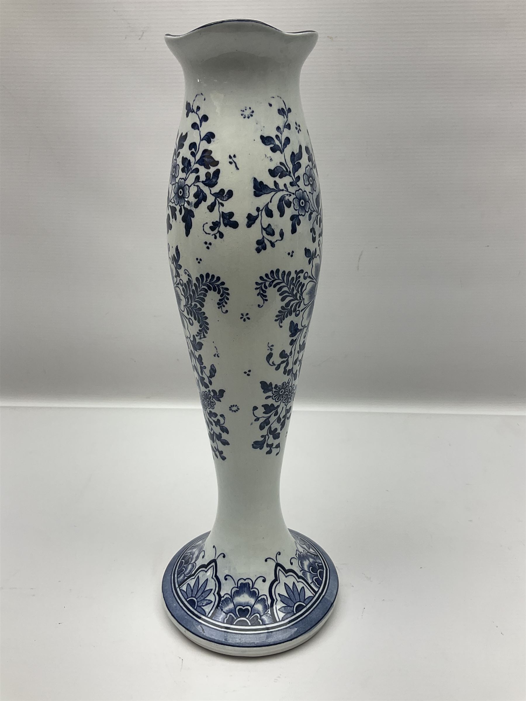 Pair of Delft blue and white vases, of elongated baluster form with shaped fluted rim, one depicting a Dutch sailing scene, the other a Dutch windmill scene, with painted mark beneath, H35.5cm