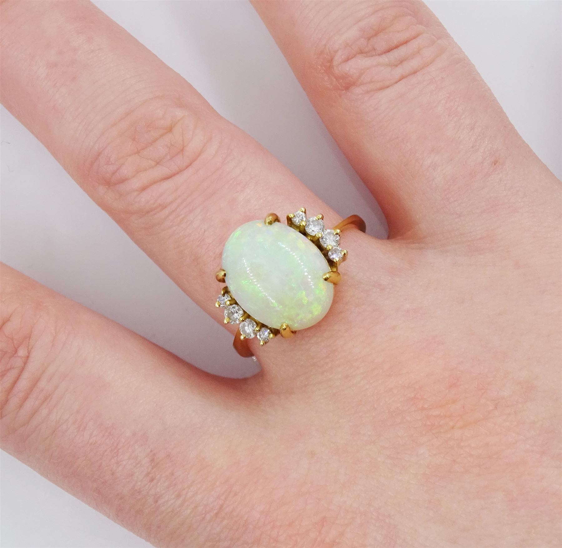 18ct gold single stone opal ring, with four round brilliant cut diamonds set either side, old opal ring, with four diamonds set either side