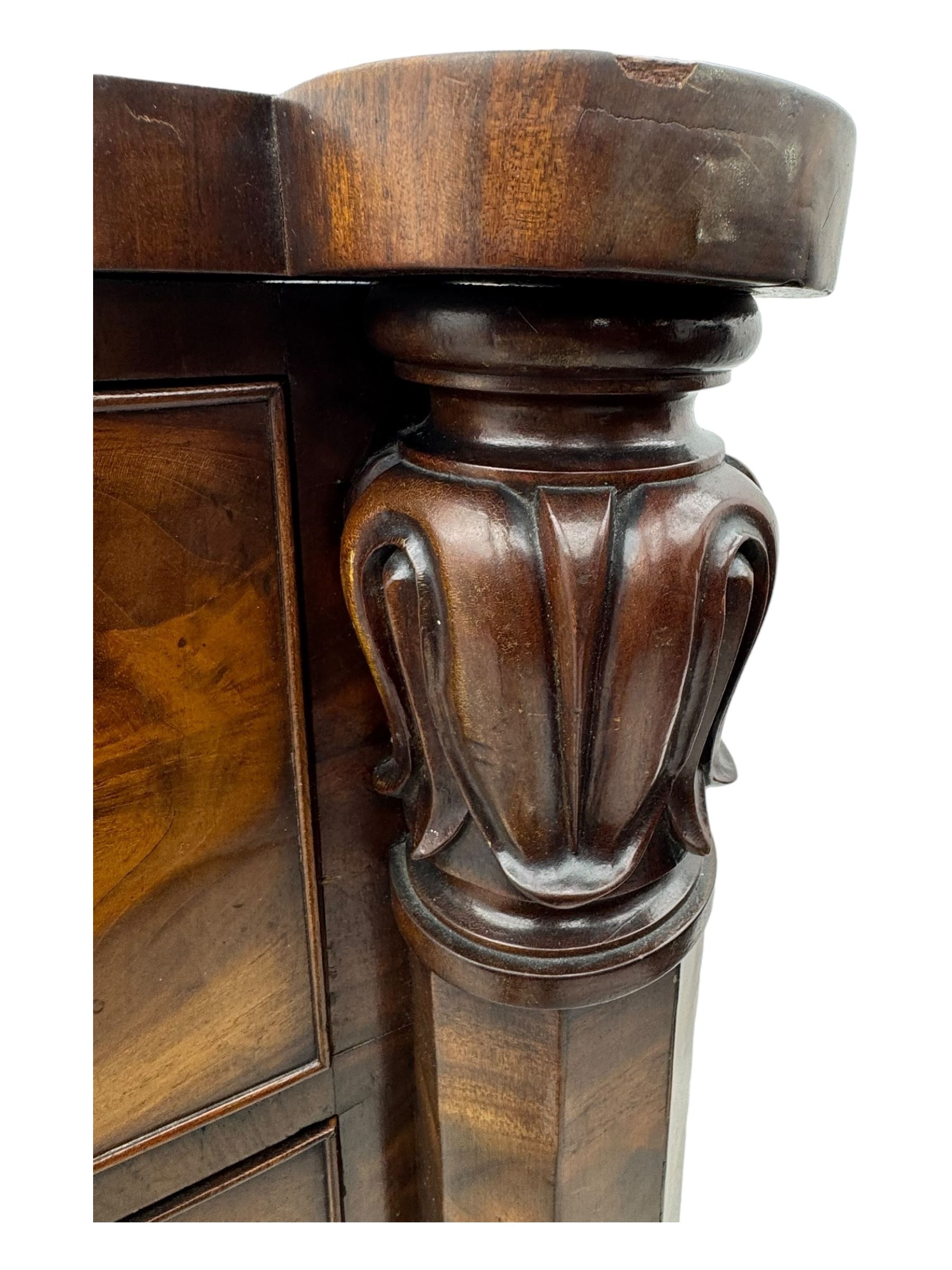 Early Victorian mahogany bow front chest, two short over three long graduating cockbeaded drawers, flanked by faceted columns with carved acanthus leaf capitals, standing on turned bun supports with fluted detailing