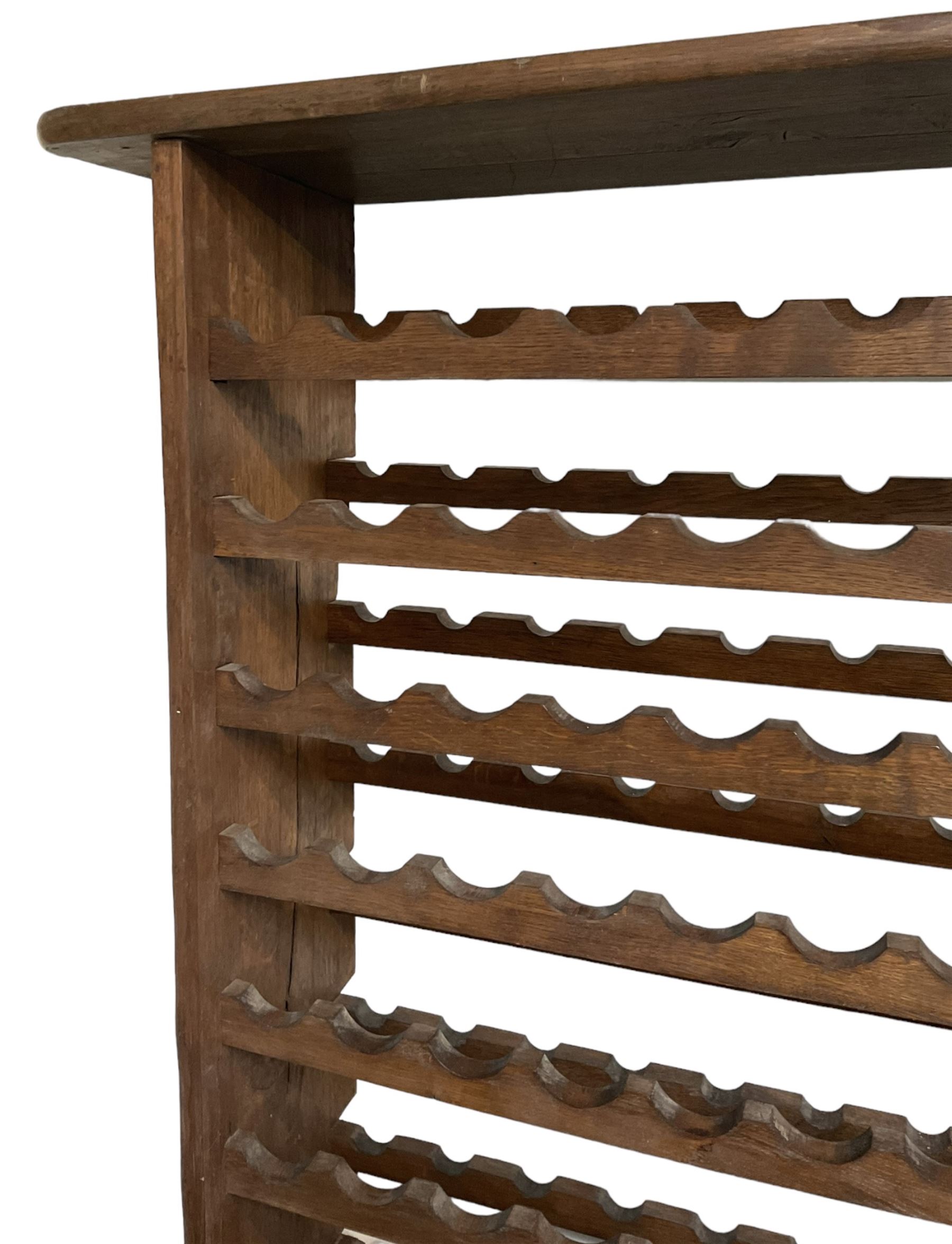 Large reclaimed oak eight tier wine rack, rectangular top over eight racks each with ten bottle divisions, on end supports