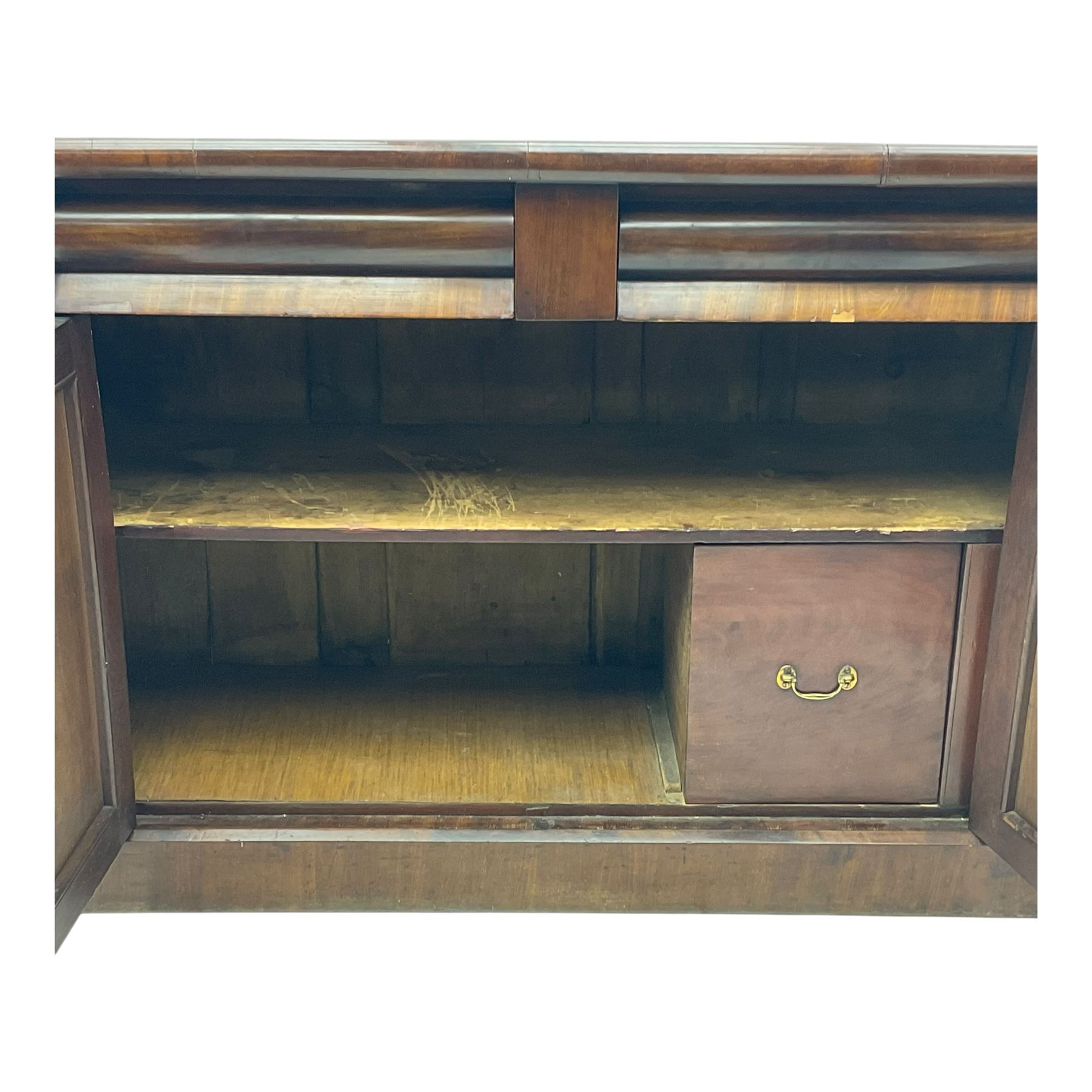 Mid 19th century mahogany sideboard, rectangular top over two frieze drawers with rounded edges, flanked by floral carved corbels, over two panelled cupboard doors, raised on a plinth base