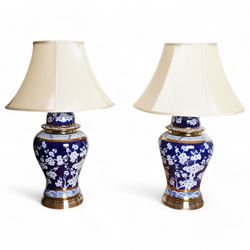 Pair of blue and white table lamps, each in the form of a vase and cover, decorated with c...