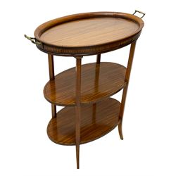 Edwardian satinwood tray top stand of oval form, tray top with glazed base and brass handles over two tiers, each with checkered inlaid band, on square tapering and splayed supports